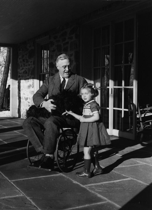 President Roosevelt in a Wheelchair, with a little girl standing by his side